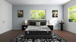 Modern bedroom with a low platform bed, black nightstands, and a large window showing green trees outside.