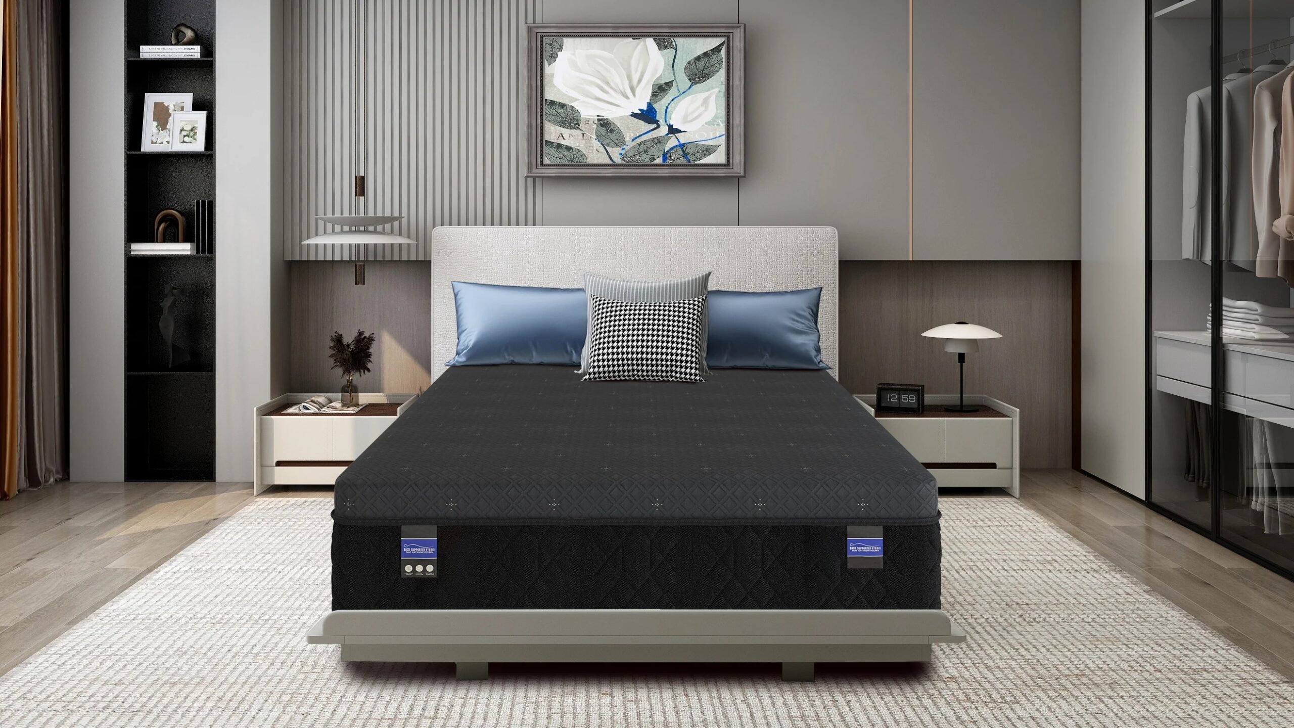 Makayla_Front_Lifestyle | Carson Mattress Outlet Store Modern contemporary bedroom with gray upholstered headboard bed, blue pillows, and a black quilted mattress flanked by white nightstands and lamps; built-in wardrobe on right and a framed floral painting above the bed.
